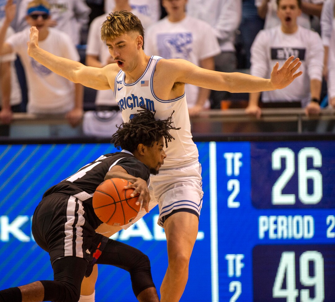 (Rick Egan  |  The Salt Lake Tribune)        Brigham Young Cougars guard Zac Seljaas (2) tries to stop Nevada Wolf Pack guard Lindsey Drew (14) as he takes the ball inside, in basketball action between the Brigham Young Cougars and the Nevada Wolf Pack, at the Marriott Center, in Provo, Saturday, December 10, 2019.