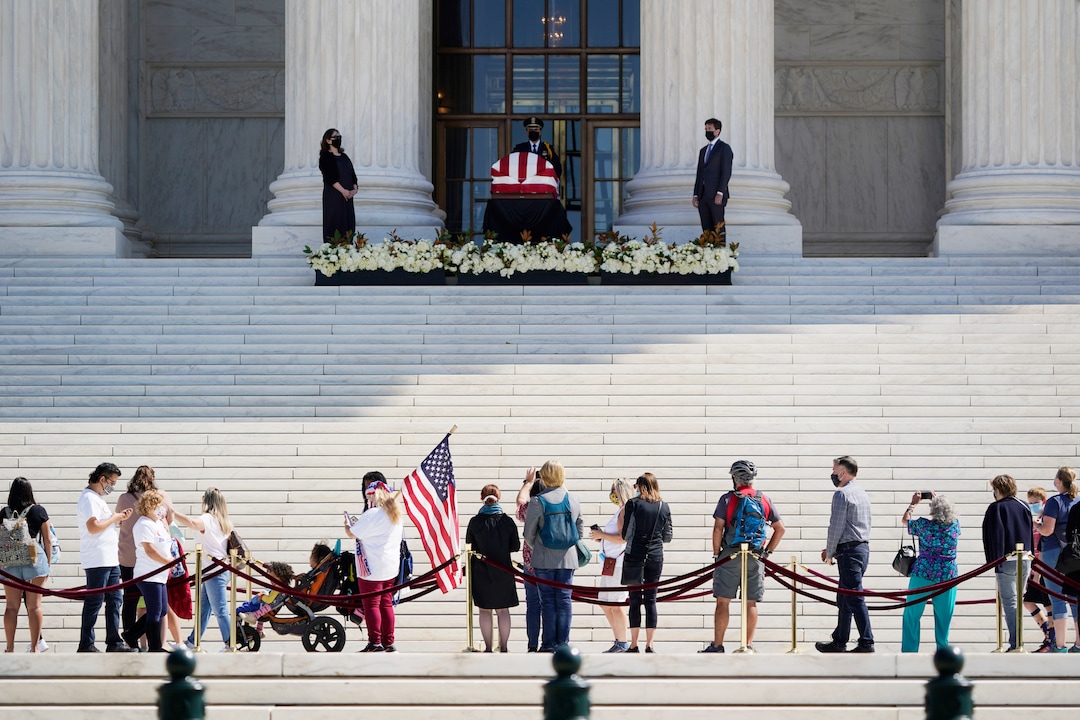 People pay respects as Justice Ruth Bader Ginsburg lies in repose under the Portico at the top of the front steps of the U.S. Supreme Court building on Wednesday, Sept. 23, 2020, in Washington. Ginsburg, 87, died of cancer on Sept. 18. (AP Photo/J. Scott Applewhite)
