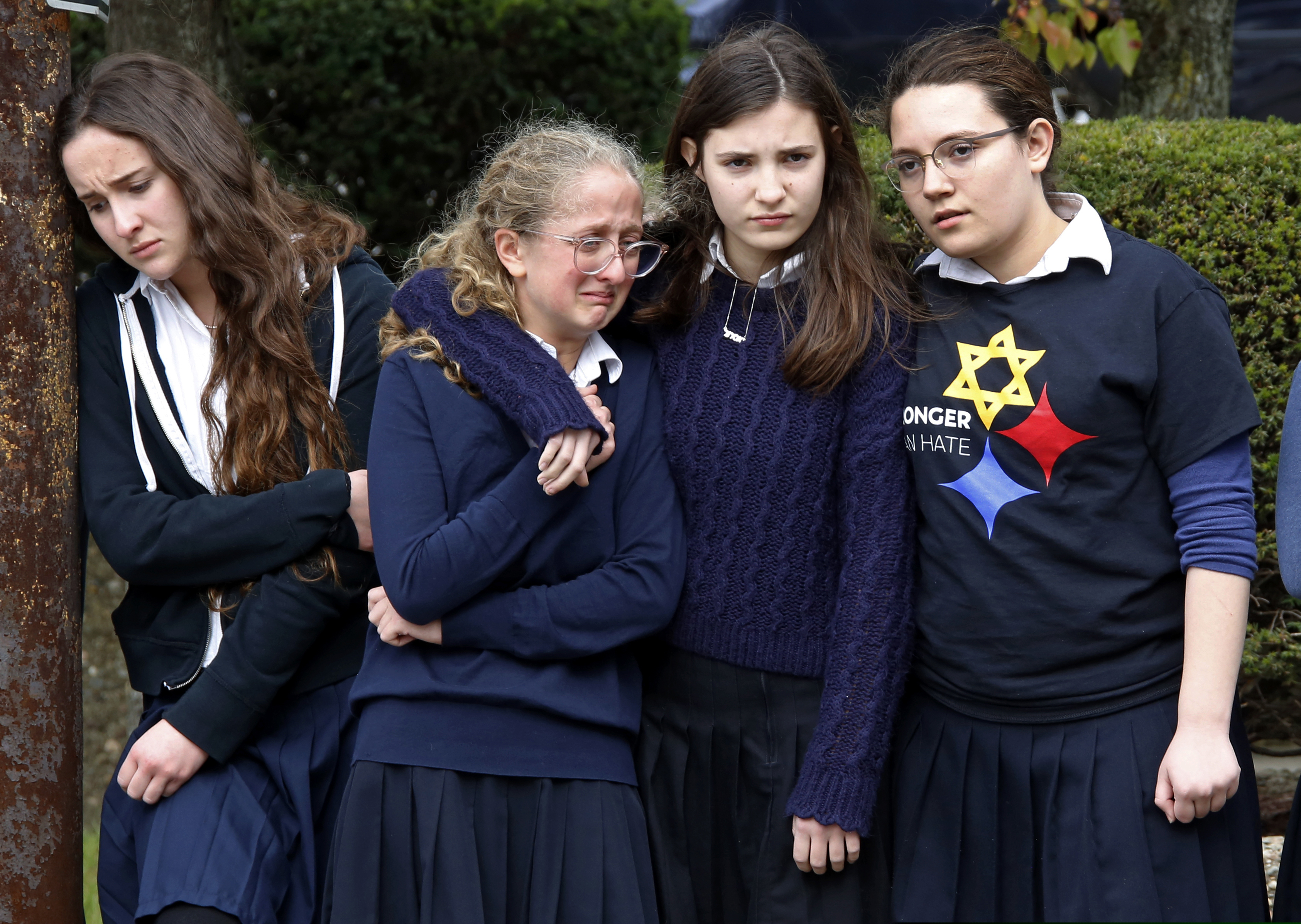 (Gene J. Puskar | AP Photo) Students from the Yeshiva School in the Squirrel Hill neighborhood of Pittsburgh, pay their respects as the funeral procession for Dr. Jerry Rabinowitz passes their school en route to Homewood Cemetery following a funeral service at the Jewish Community Center, Tuesday Oct. 30, 2018. Rabinowitz was one of people killed while worshipping at the Tree of Life synagogue on Saturday, Oct. 27, 2018.