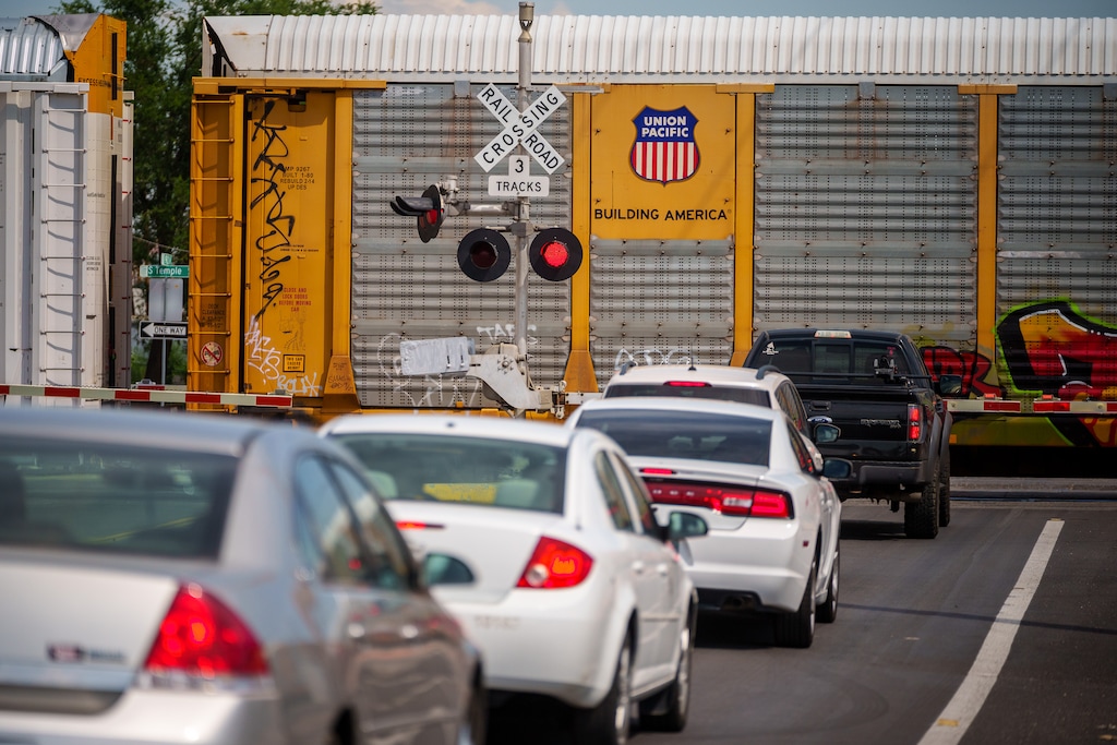 (Trent Nelson  |  The Salt Lake Tribune) A train stops, blocking traffic on 900 West in Salt Lake City, on Thursday, Aug. 18, 2022.