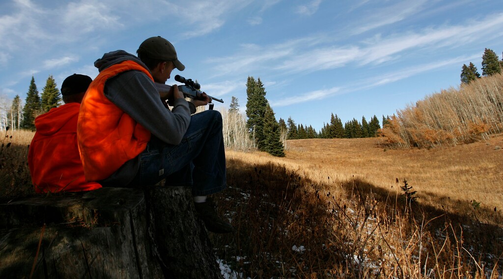 (Leah Hogsten | Tribune File Photo) Colton Thompson (left) of Clinton and Austin Bennett (right) of Riverdale scope the  hills and forest near Six Bit Springs in the Monte Cristo area of Cache National Forest in 2008.