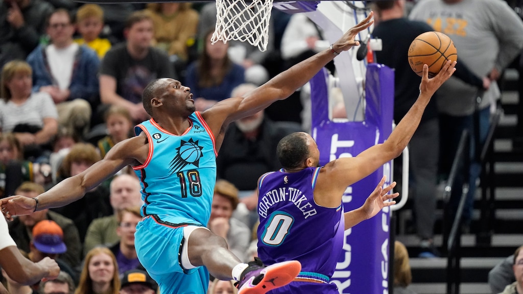 Phoenix Suns center Bismack Biyombo (18) defends against Utah Jazz guard Talen Horton-Tucker (0) during the second half of an NBA basketball game Monday, March 27, 2023, in Salt Lake City. (AP Photo/Rick Bowmer)
