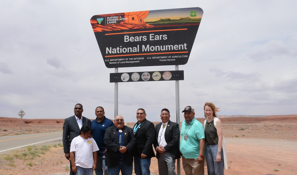 (Bureau of Land Management) Federal agency leaders and tribal representatives on the Bears Ears Commission stand in front of the newly installed Bears Ears National Monument sign on June 18, 2022. Pictured from left, former Agriculture Department Under Secretary Homer L. Wilkes, Ute Indian Tribe Business Committee Member Christopher Tabbee, Ute Mountain Ute Councilman Malcolm Lehi, Zuni Tribe Lieutenant Governor Carleton R. Bowekaty, Hopi Chairman Timothy Nuvangyaoma, Navajo Nation Executive Assistant Davis Filfred and BLM Director Tracy Stone-Manning.