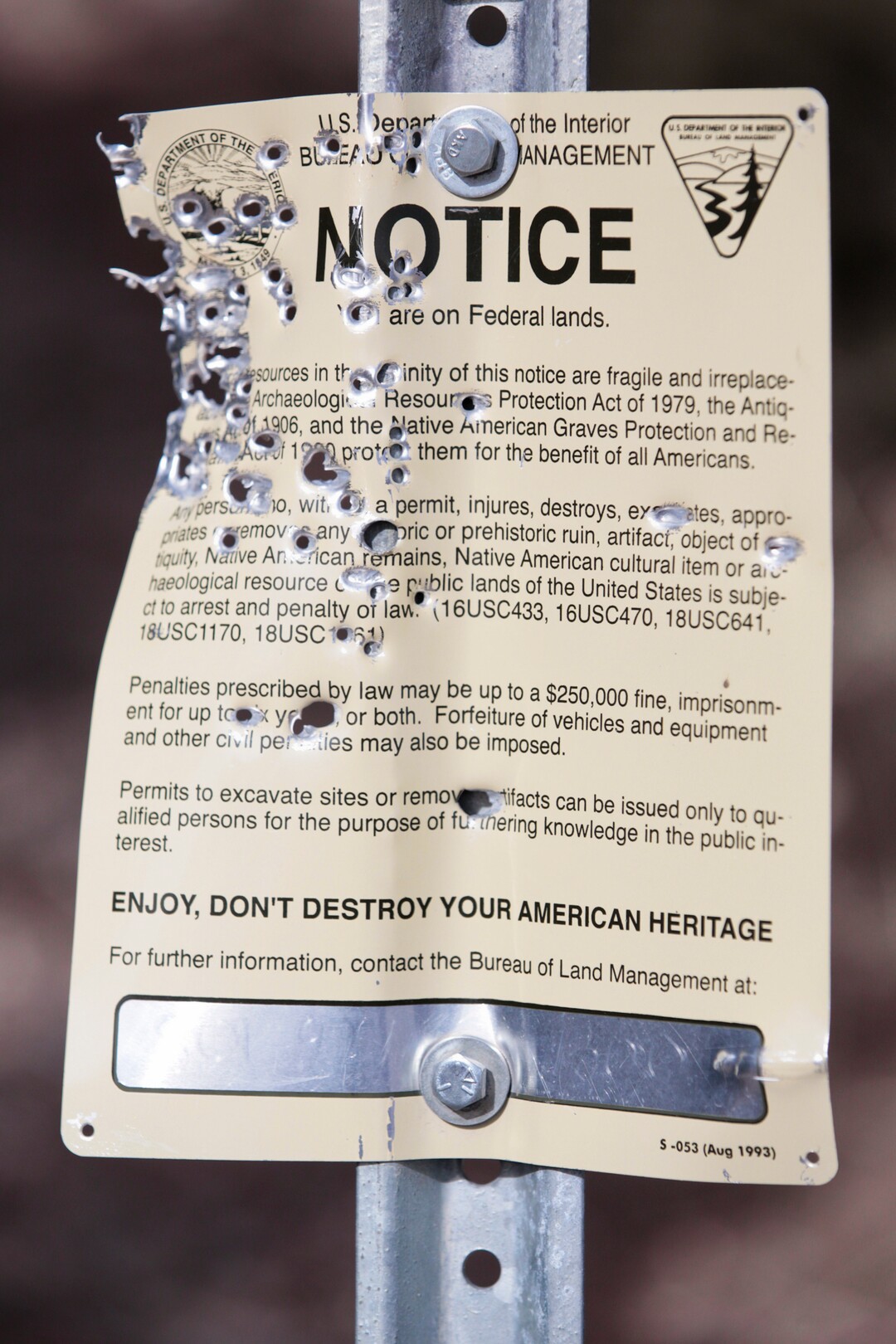 Bullet holes riddle a Bureau of Land Management sign in the Lake Mountains area of Utah on Thursday, Feb. 8, 2018. The sign explains that the area has archaeological artifacts and that penalties will be enforced if damage is done to the historical objects. (Evan Cobb/The Daily Herald via AP)