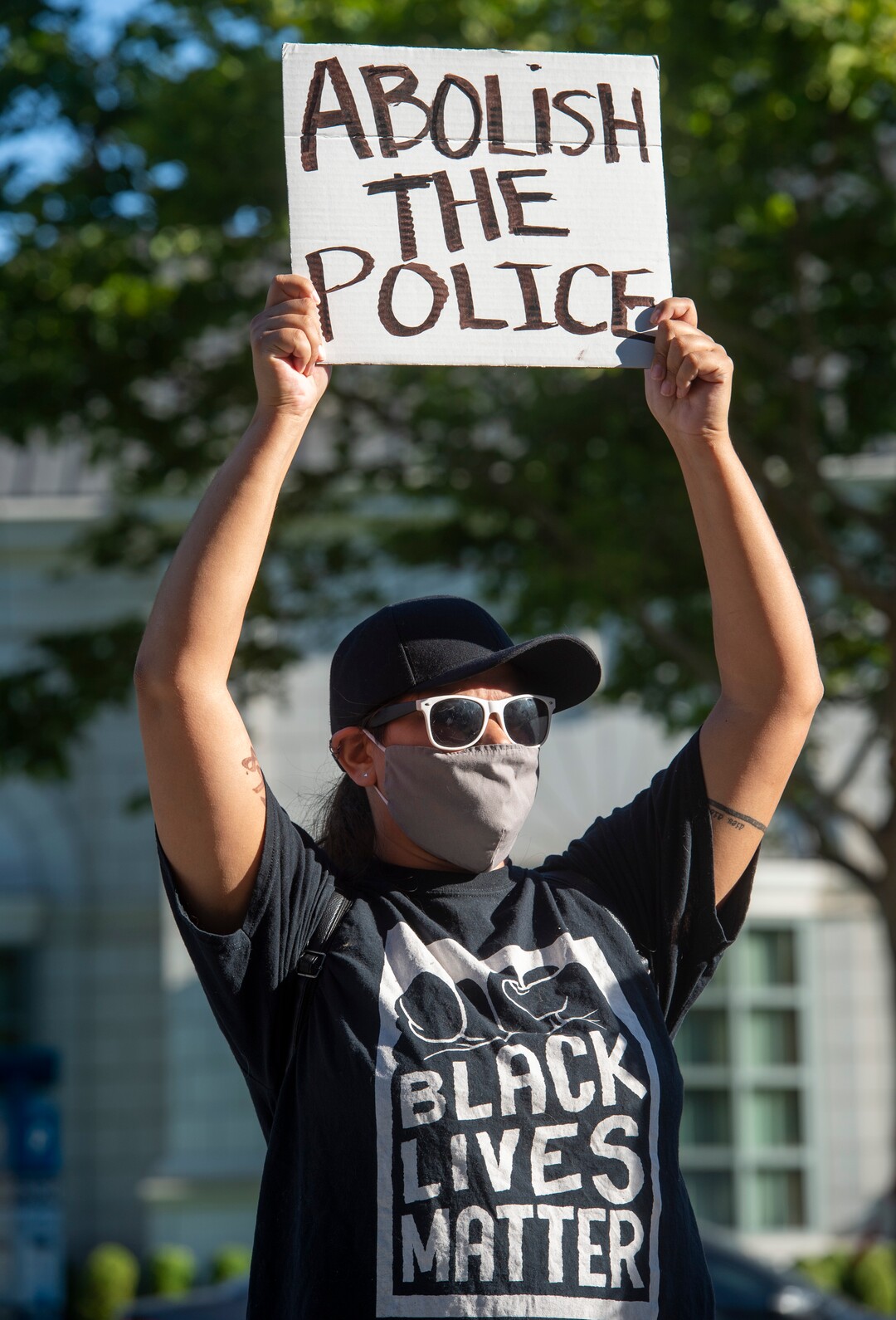(Rick Egan  |  The Salt Lake Tribune)     Cim holds a sign as she joins protesters in front of the Salt Lake District Attorney's Office, during a protest to draw attention to Chad Breinholt and Bryan Valencia, who, like Bernardo Palacios were killed by the police, Wednesday, July 8, 2020.