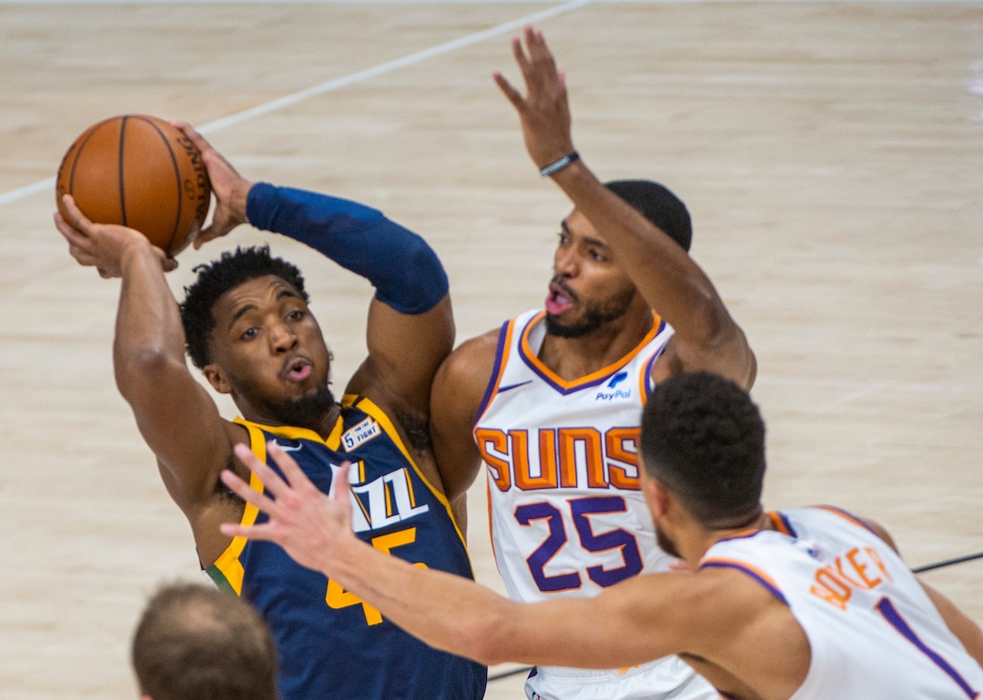 (Rick Egan | The Salt Lake Tribune) Utah Jazz guard Donovan Mitchell (45) is double-teamed by Phoenix Suns guard Devin Booker (1) and Phoenix Suns forward Mikal Bridges (25), in NBA action between the Utah Jazz and the Phoenix Suns, on Thursday, Dec. 31, 2020.