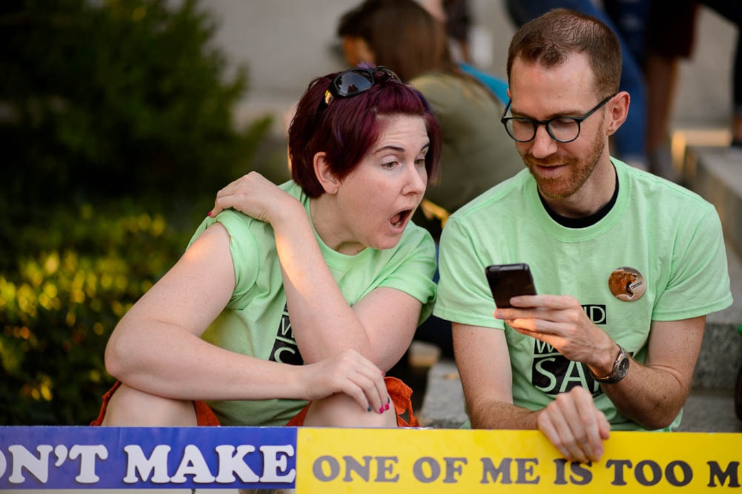 (Trent Nelson | The Salt Lake Tribune)  Michelle and Steve Boyer watch Sam Young speak on a livestream after his hearing. People gathered in front of the LDS Church Administration Building Salt Lake City, Sunday Sept. 9, 2018 in support of Sam Young. Young was in a disciplinary hearing tonight after he made calls for changes to the church's youth interview process.