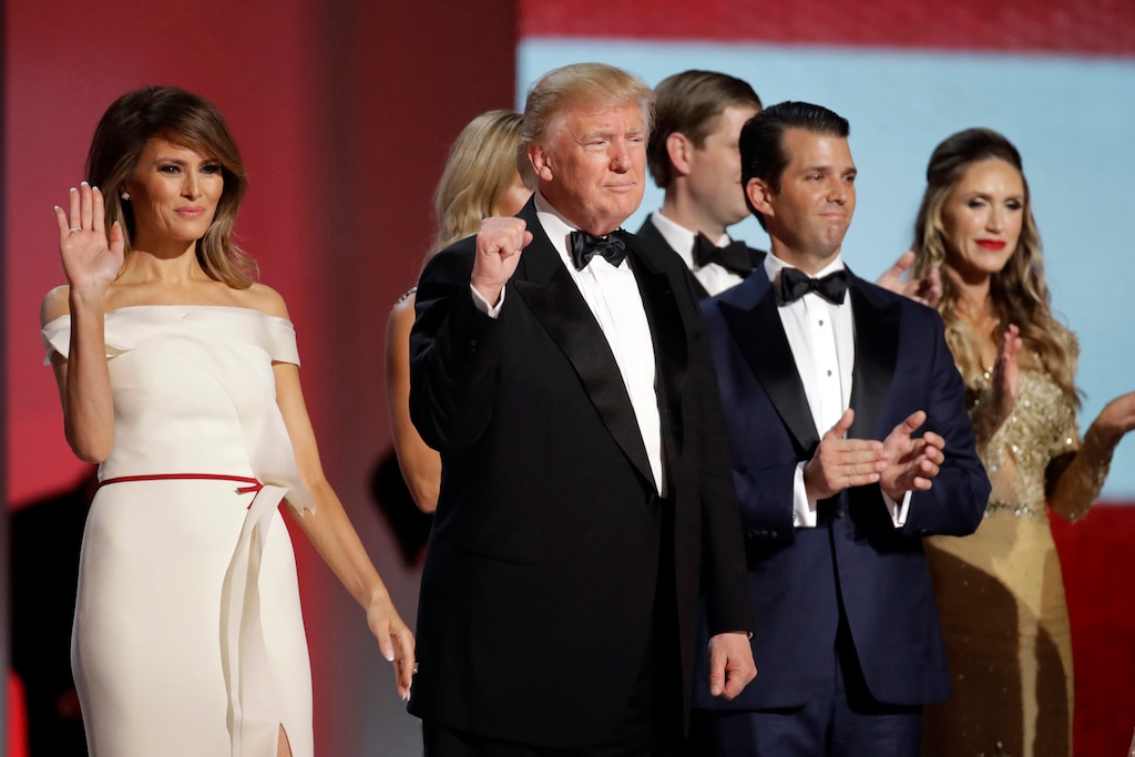 FILE - In this Jan. 20, 2017, file photo President Donald Trump, center, raises his fist alongside first lady Melania Trump, left, and son Donald Trump, Jr., after dancing at the Liberty Ball following his inauguration in Washington. Federal prosecutors are reportedly investigating the finances of Trump's inaugural committee and whether foreigners made illegal contributions to its events. (AP Photo/Patrick Semansky)