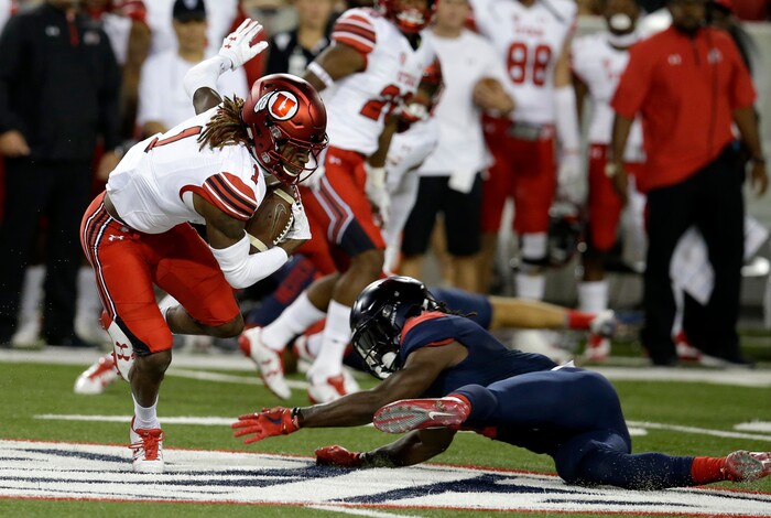 Utah's Boobie Hobbs (1) avoids the tackle from Arizona's Demetrius Flannigan-Fowles on a punt return during the first half of an NCAA college football game, Friday, Sept. 22, 2017, in Tucson, Ariz. (AP Photo/Rick Scuteri)