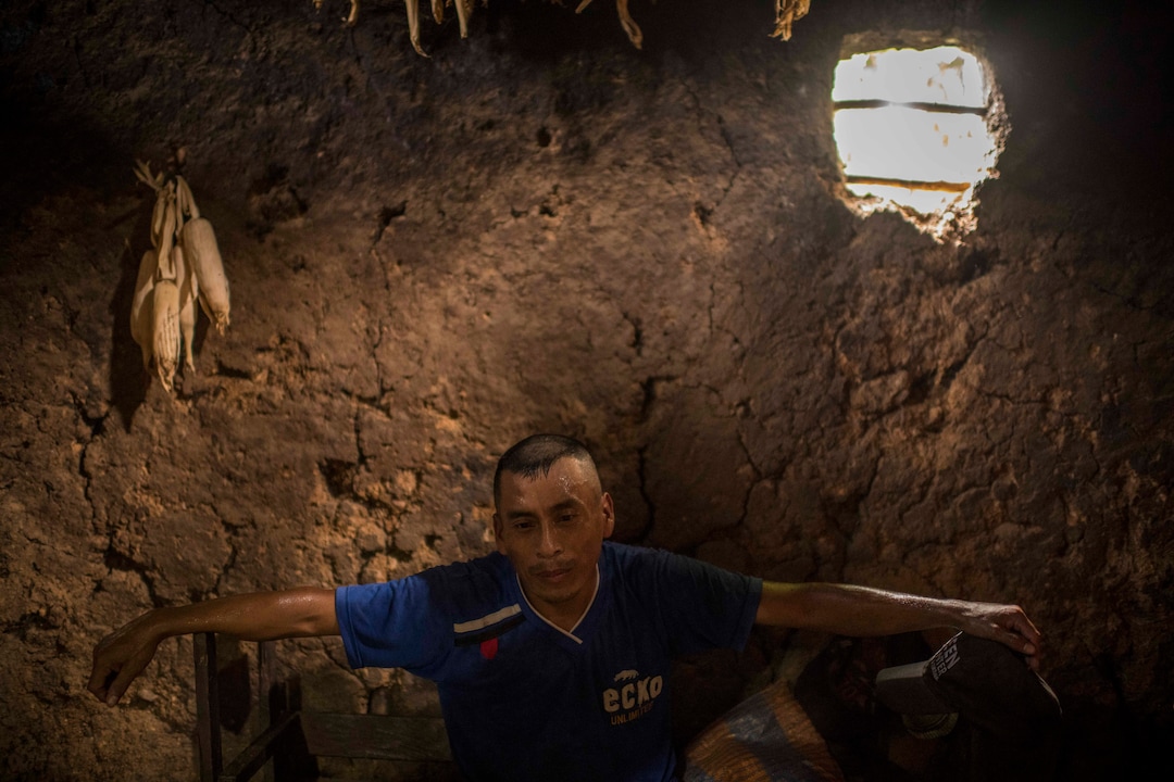 (Daniele Volpe | The New York Times) Eduardo Roque, an indigenous farmer, rests in the mud home he built by hand in La Palmilla, in the Chiquimula region of Guatemala, July 23, 2020. Around the world, the poor and marginalized are much more likely to be vulnerable to extreme heat; in the past decade, five long and harsh late summer droughts have cursed this region known as the "Dry Corridor."