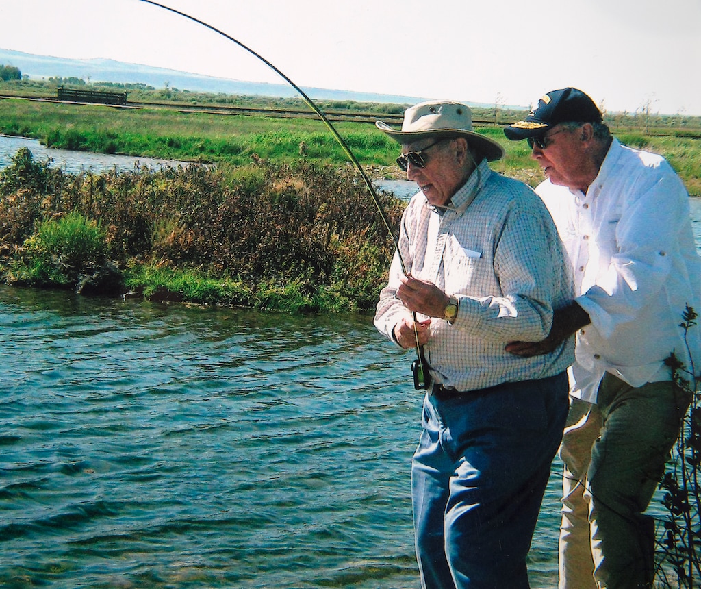 (photo courtesy Huntsman family) President Thomas S. Monson is steadied by Jon Huntsman Sr., as he tries to a land a trout.