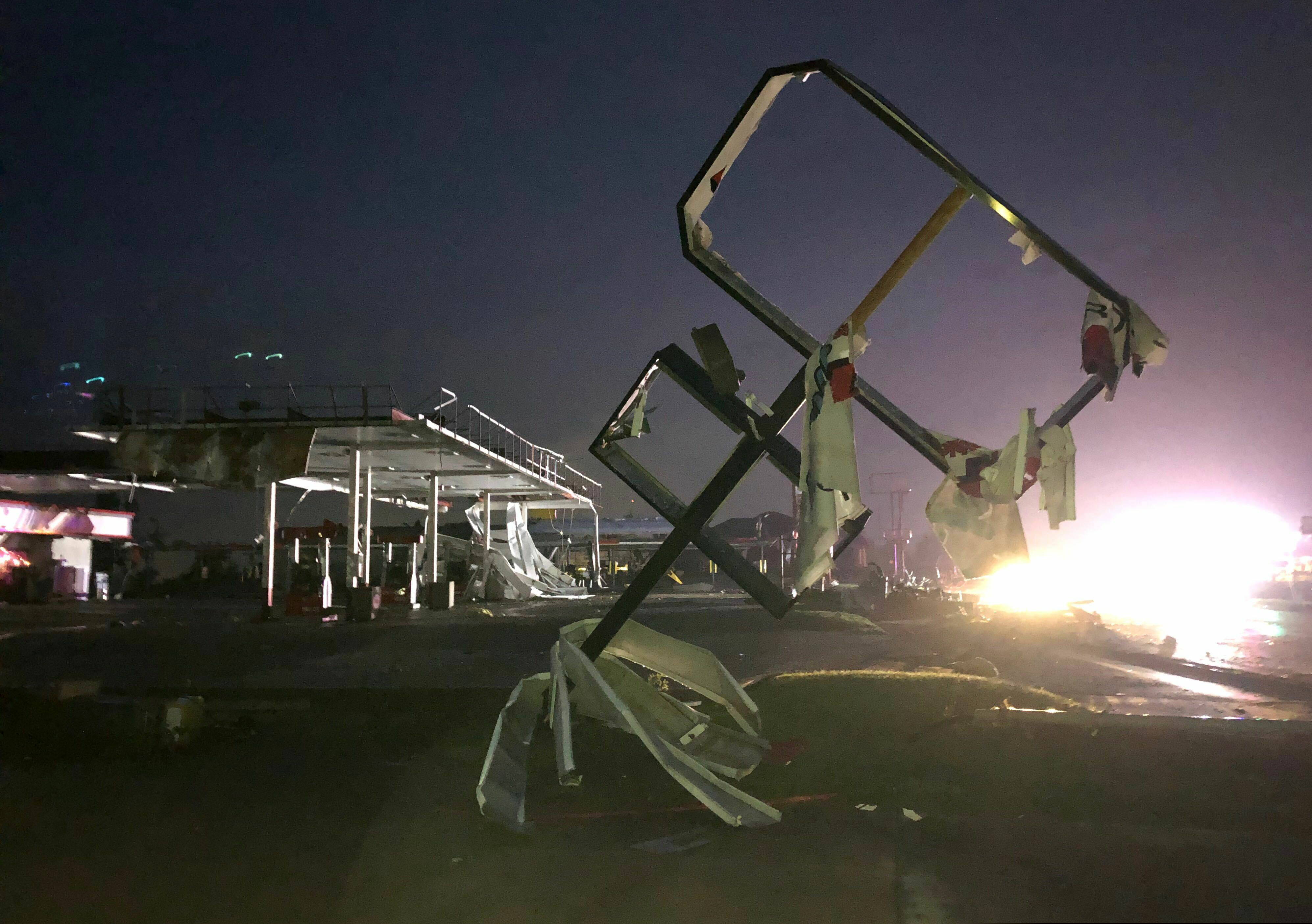 (David A. Lieb | AP) A destroyed sign for a car wash is seen in tornado-hit Jefferson City, MO., Thursday, May 23, 2019. The heavily damaged gas station is at background. The National Weather Service has confirmed a large and destructive tornado has touched down in Missouri's state capital, causing heavy damage and trapping multiple people in the wreckage of their homes.