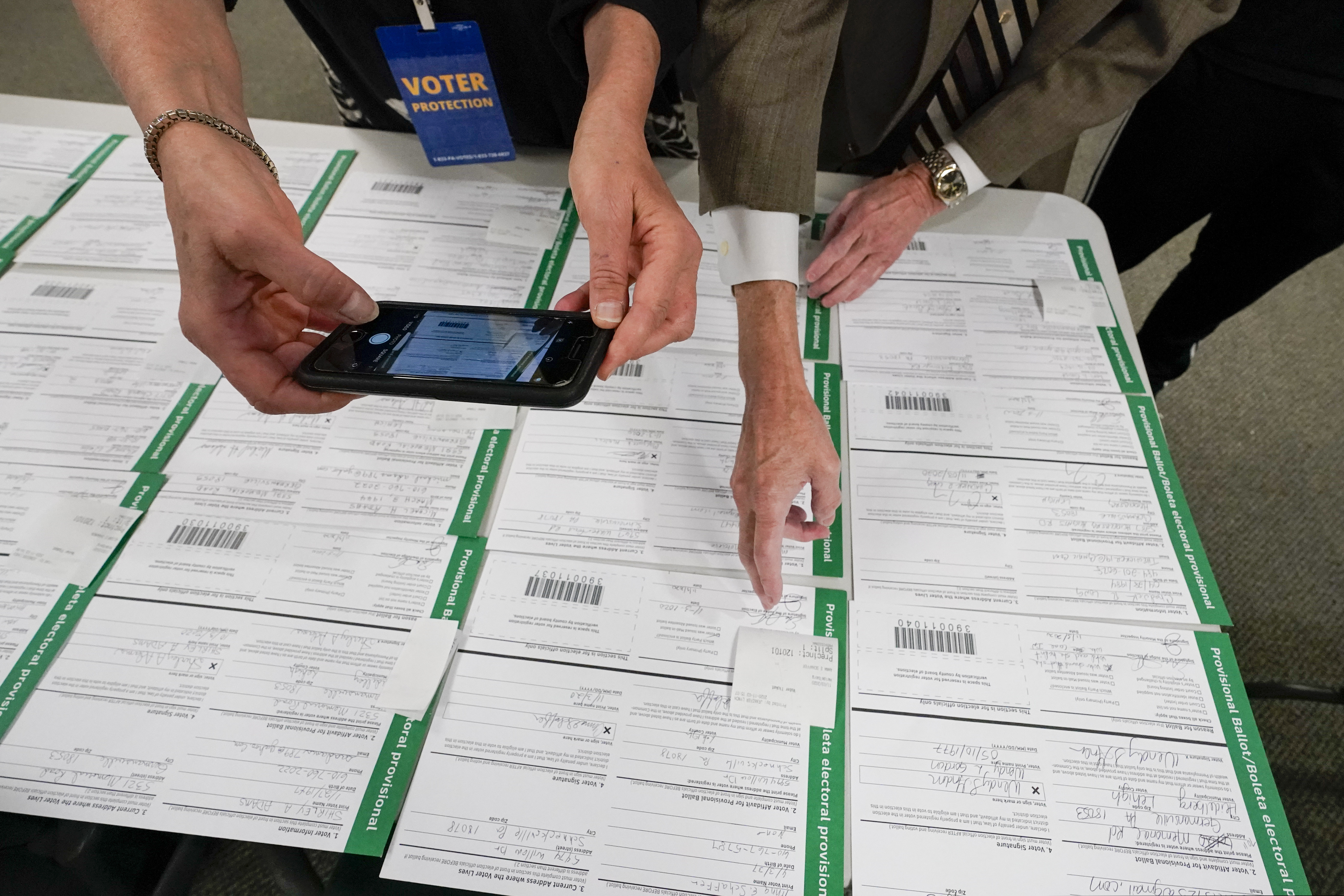 (Mary Altaffer | AP file photo) A canvas observer photographs Lehigh County provisional ballots as vote counting in the general election continues on Nov. 6, 2020, in Allentown, Pa. President Donald Trump’s campaign filed a number of lawsuits across six battleground states this month as he tried to upend the 2020 election. Judges uniformly rejected his claims of vote fraud. The latest case ended Saturday, Nov. 21, when a federal judge in Pennsylvania said Trump lawyer Rudy Giuliani presented only "speculative accusations" that brought to mind "Frankenstein’s Monster."