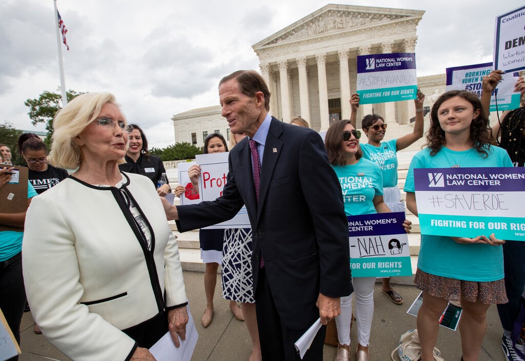 Lilly Ledbetter, an activist for workplace equality, left, is joined by Sen. Richard Blumenthal, D-Conn., a member of the Senate Judiciary Committee, as they address demonstrators opposed to President Donald Trump's Supreme Court nominee, Judge Brett Kavanaugh, in front of the Supreme Court, in Washington, Wednesday, Aug. 22, 2018. (AP Photo/J. Scott Applewhite)