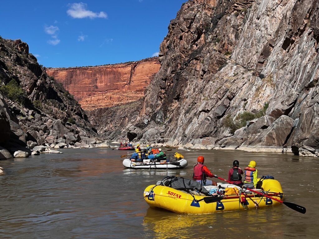 (Bureau of Land Management) Volunteers paddle through Westwater Canyon during a National Public Lands Day cleanup trip, where participants joined Bureau of Land Management river rangers to remove trash and invasive weeds from the canyon in September 2025.