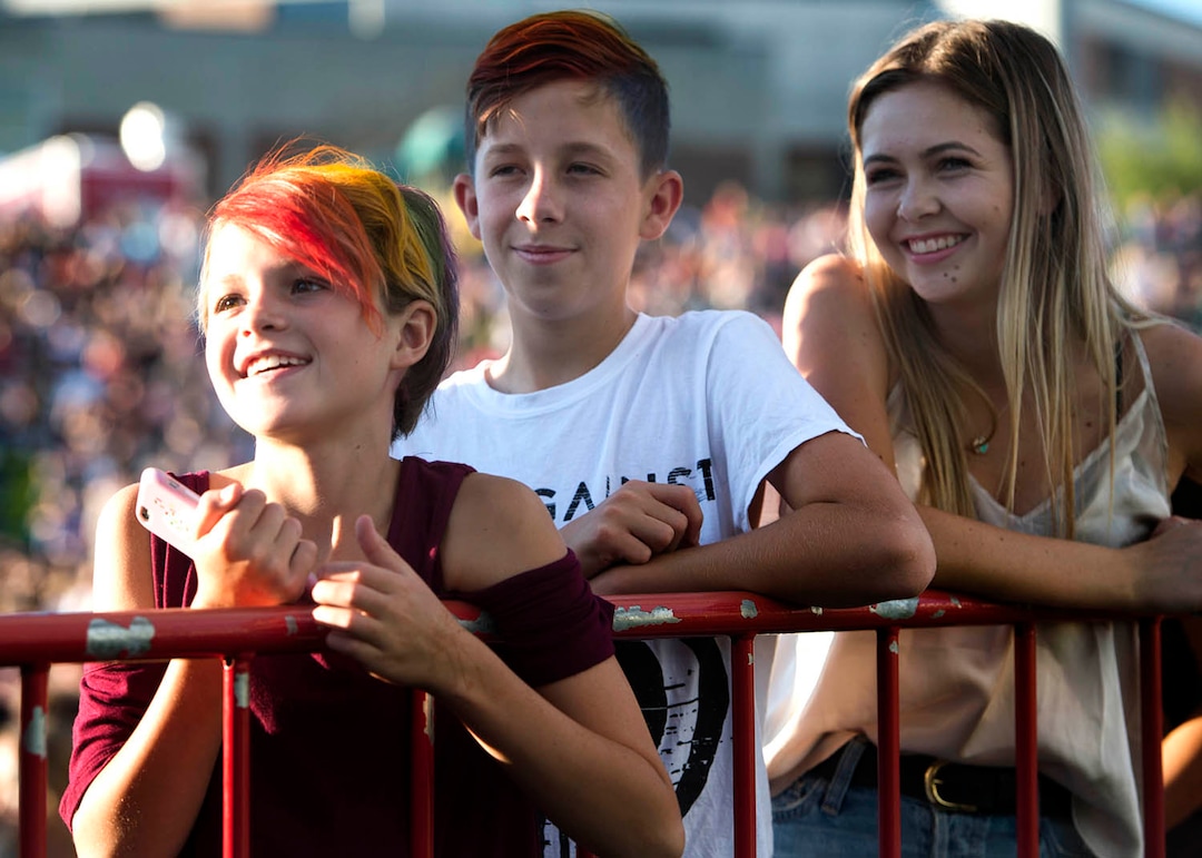 (Rick Egan  |  The Salt Lake Tribune)   Bailey Harris, 11, McKay Harris 12, and Kalena Evans, watch the entertainment at the LoveLoud Festival at Brent Brown Ballpark at UVU campus, Saturday, August 26, 2017.