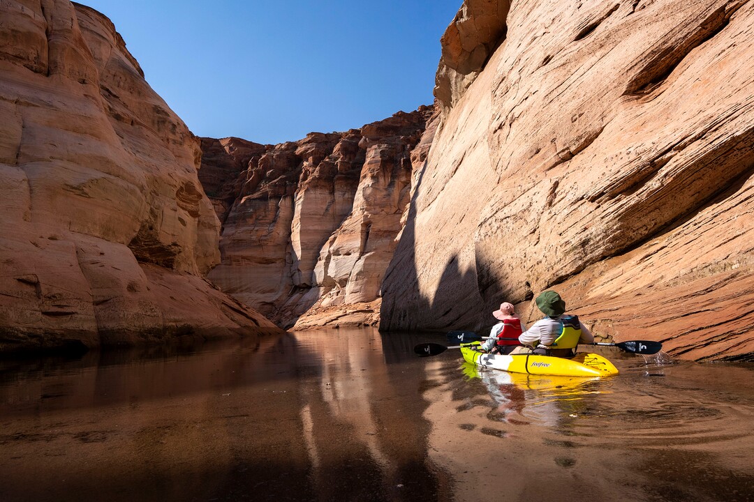 (Rick Egan | The Salt Lake Tribune)  A woman paddles a Kayak down Antelope Canyon, on Wednesday, Aug. 4, 2021. Water levels are dropping a few inches a day, which may bring an early end to kayaking in Glen Canyon in the next week or so, shortening a season that usually goes through the end of October.