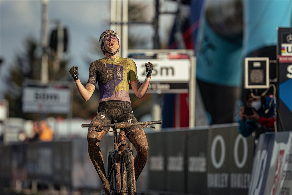(Photo courtesy of Jan Brychta /mtb-nmnm.cz) Park City native Haley Batten, 22, is coated in mud and elation Friday, May 14, 2021, as she celebrates her first World Cup mountain biking win as an elite in Nove Mesto, Czech Republic. Batten placed second in the long-course race Sunday, which should be enough to secure her a spot on the USA team at the Olympics in Tokyo.