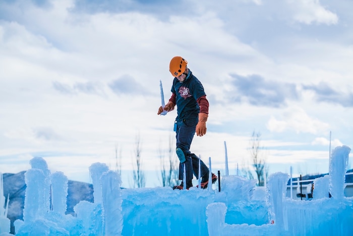 (A.J. Mellor |  courtesy of Ice Castles) An artisan places icicles in the framework of the Ice Castles installation in Midway, Utah. The one-acre walk-through ice-and-light show is expected to open to the public in late December.