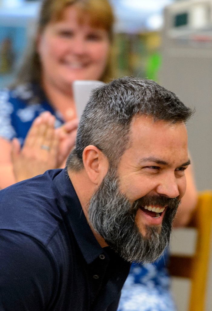 (Steve Griffin  |  The Salt Lake Tribune)  Franklin Elementary School special education teacher Jason Adam Tackett smiles as he is surprised by the announcement, from Karen Huntsman, that he has won the Huntsman Award for Excellence in Education, as Huntsman surprised him during the school's faculty meeting in Salt Lake City Monday April 23, 2018. With the award comes a $10,000 cash prize.