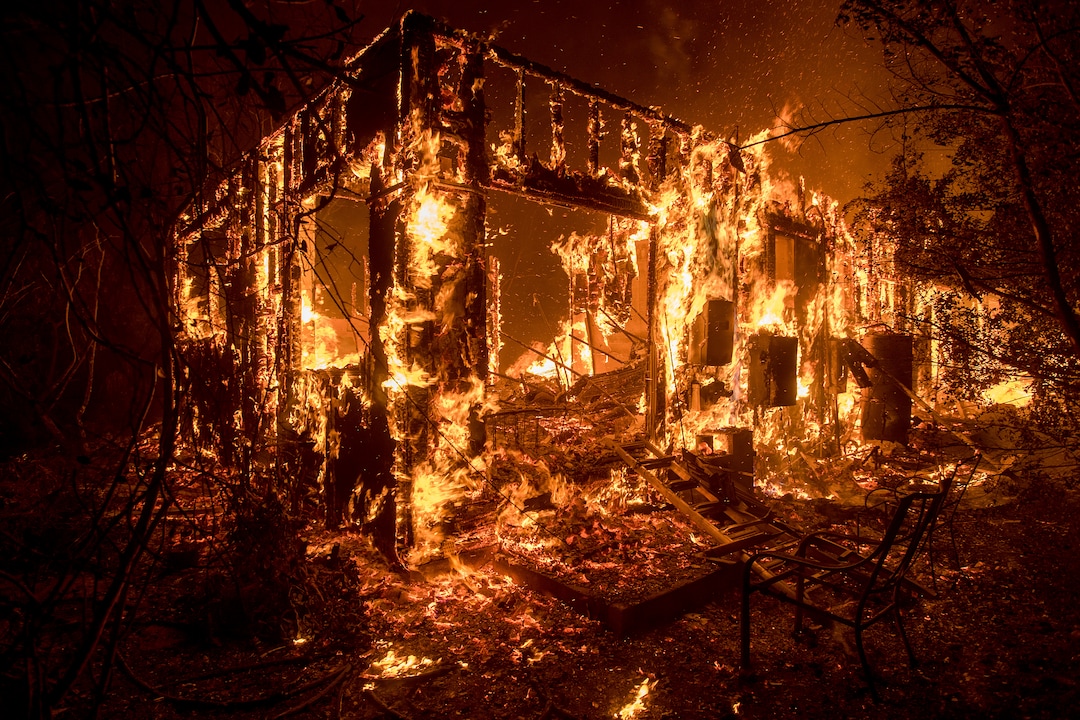 Flames consume a home as a wildfire burns in Ojai, Calif., on Thursday, Dec. 7, 2017. (AP Photo/Noah Berger)