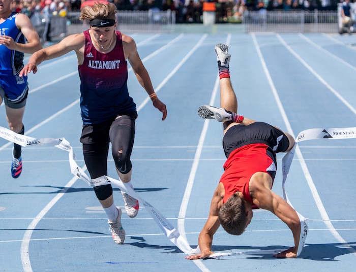 (Rick Egan | The Salt Lake Tribune)  Altamont's Ethan Hansen finishes in second place as Blake Barnes dives headfirst into the finish line for a first place finish in the 1A Boys 200 meter dash, at the State High School Championships at BYU, on Saturday, May 21, 2022.
