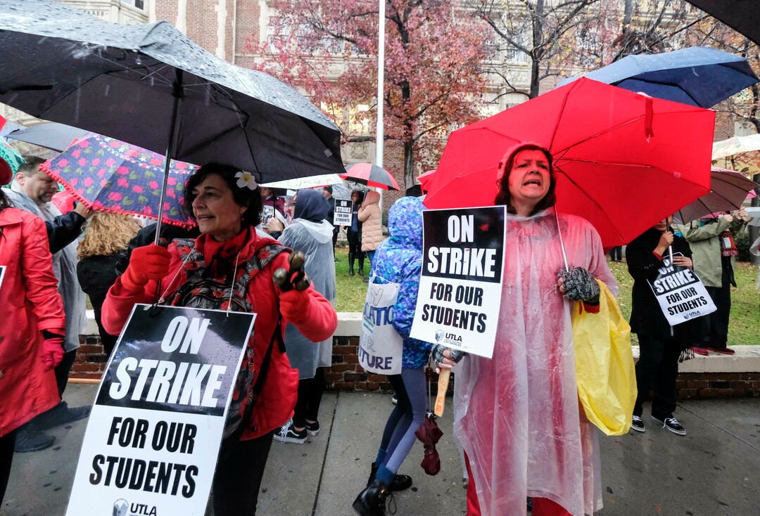 (Ringo H.W. Chiu | The Associated Press)  Teachers strike in the rain outside John Marshall High School, Monday, Jan. 14, 2019, in Los Angeles. Tens of thousands of Los Angeles teachers are striking after contentious contract negotiations failed in the nation's second-largest school district.