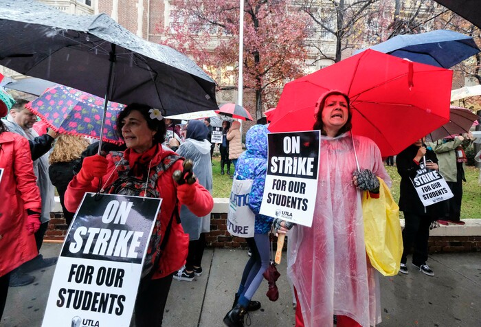(Ringo H.W. Chiu | The Associated Press)  Teachers strike in the rain outside John Marshall High School, Monday, Jan. 14, 2019, in Los Angeles. Tens of thousands of Los Angeles teachers are striking after contentious contract negotiations failed in the nation's second-largest school district.