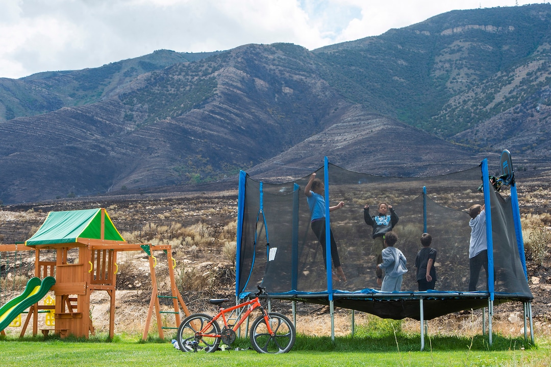 (Rick Egan  |  The Salt Lake Tribune)      Kids play on their trampoline after returning from yesterdays vacuation, as the Knolls did some property damage, but spared the homes on Sunrise Drive in Sunday's fire, in Saratoga Springs, Monday, June 29, 2020.
