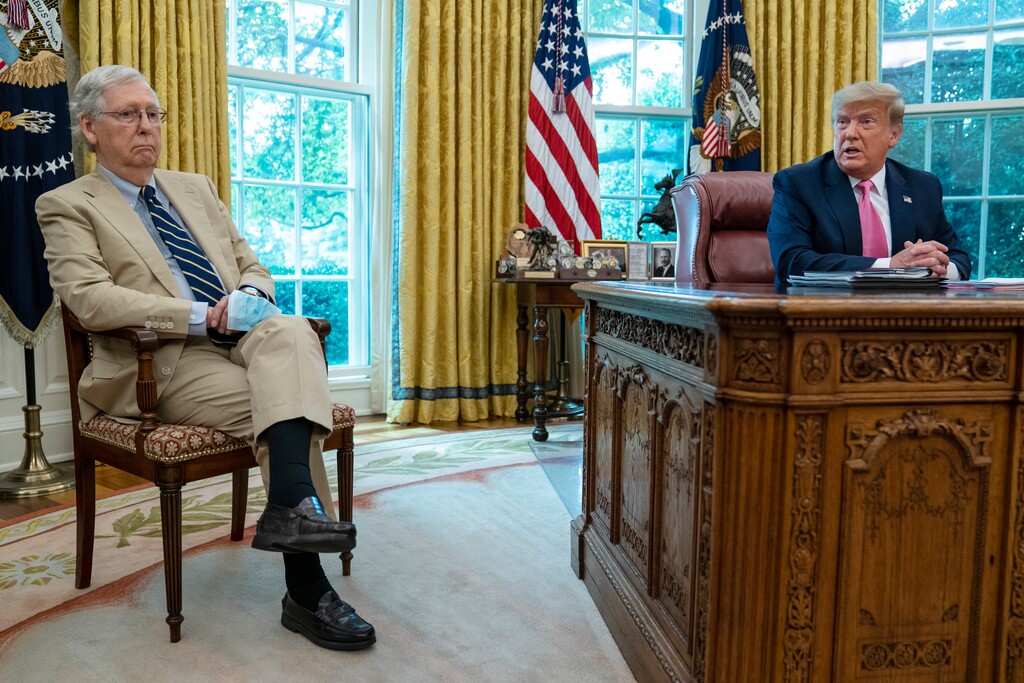 (Evan Vucci | AP)  Senate Majority Leader Mitch McConnell of Ky., listens as President Donald Trump speaks during a meeting in the Oval Office of the White House, Monday, July 20, 2020, in Washington.