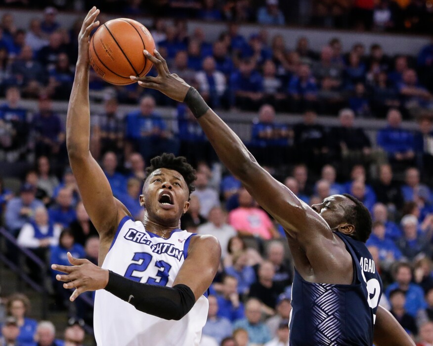 FILE - In this Sunday, Feb. 19, 2017 file photo, Creighton's Justin Patton (23) is blocked by Georgetown's Akoy Agau, right, during the second half of an NCAA college basketball game in Omaha, Neb. The role of the big man has changed in the NBA, and that’s evident in the way teams pick centers and post players entering the draft on Thursday, June 22, 2017. Patton, a redshirt freshman, was the Big East freshman of the year and is a possible first-round pick in Thursday's NBA draft. (AP Photo/Nati Harnik, File)