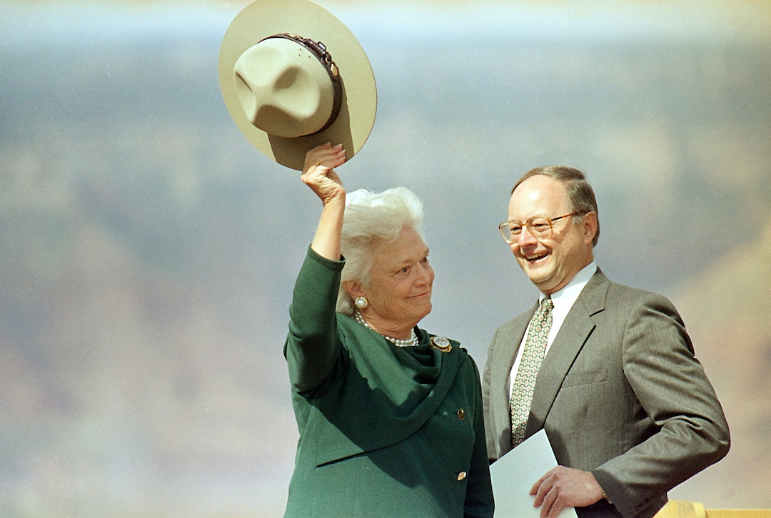 FILE - In this April 12, 1991, file photo, first lady Barbara Bush waves a park ranger hat to the crowd after receiving it from James Ridenour, director of the National Park Service, right, at Grand Canyon National Park, Ariz. A family spokesman said Tuesday, April 17, 2018, that former first lady Barbara Bush has died at the age of 92. (AP Photo/Jeff Robbins, File)