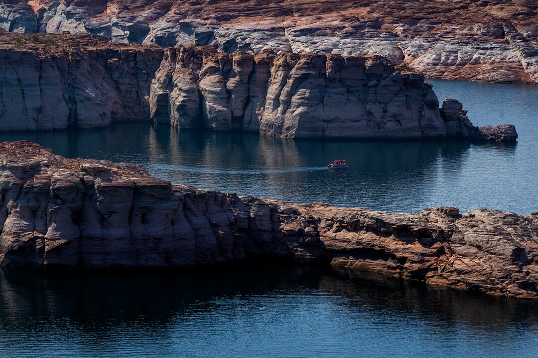 (Rick Egan | The Salt Lake Tribune)  Boats travel near the Glen Canyon Dam, on Tuesday, Aug. 3, 2021.