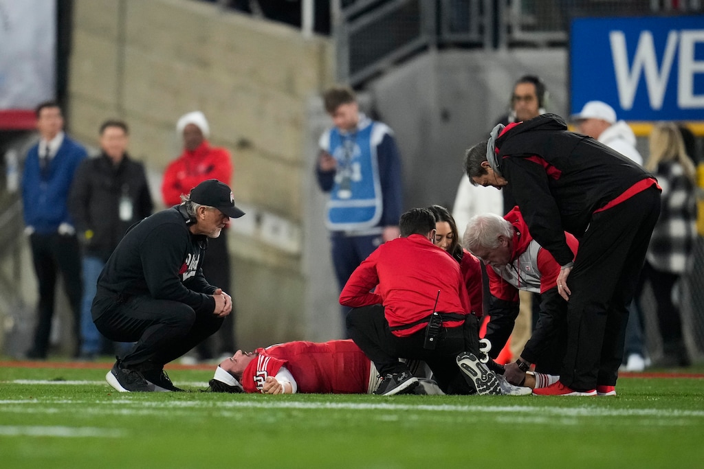 (Marcio Jose Sanchez | AP) Head coach Kyle Whittingham, left, watches as Utah quarterback Cameron Rising (7) is tended to by trainers during the second half in the Rose Bowl NCAA college football game against Penn State Monday, Jan. 2, 2023, in Pasadena, Calif.