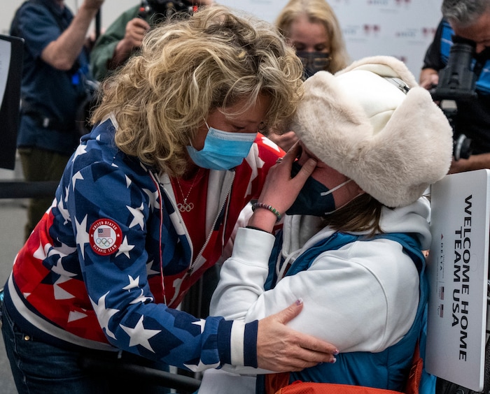 (Rick Egan | The Salt Lake Tribune) Christina Stevens, left, the mother of Olympic freestyle skier Darian Stevens, gives freestyle skier, Caroline Claire a hug as she and other Team USA Olympians arrive at the Salt Lake City International Airport on Monday, Feb. 21, 2022.