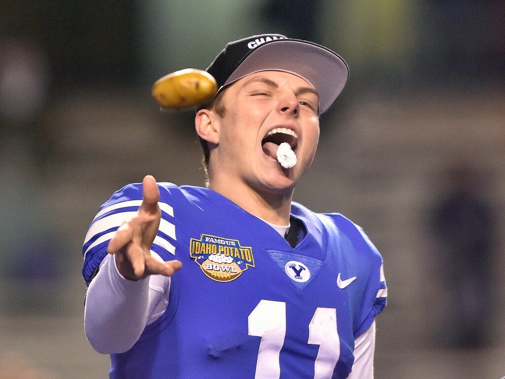 BYU quarterback Zach Wilson (11) bites off a piece of potato and tosses the remainder to the crowd after receiving the MVP trophy after the Famous Idaho Potato Bowl NCAA college football game against Western Michigan on Friday, Dec. 21, 2018, in Boise, Idaho. BYU won 49-18. (Drew Nash/The Times-News via AP)