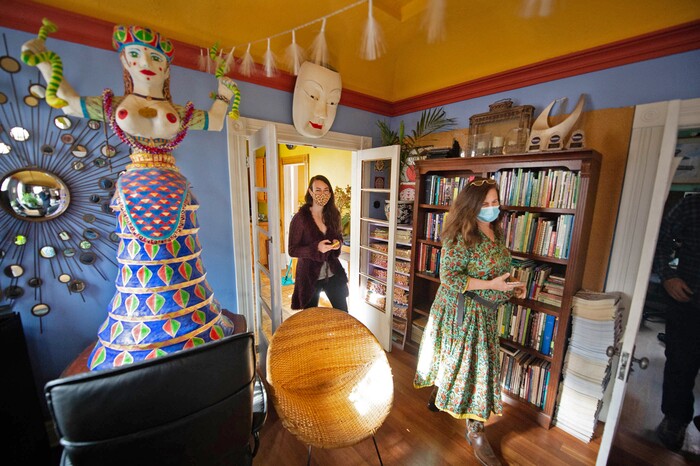 (Francisco Kjolseth  |  The Salt Lake Tribune) Sophie Silverstone, left, communications outreach director for Catalyst magazine, and art director Polly Mottonen, walk through the company’s HQ, a large pink house called “Big Pink.” The Salt Lake City-based magazine for wellness and other New Age topics, is ending its print run after nearly 40 years — shifting to online publication.