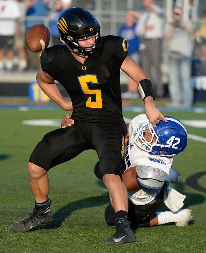(Francisco Kjolseth  |  The Salt Lake Tribune)  Orem's quarterback Cooper Legas is taken down by Bingham's Sione Fotu in the first half of the game Thursday, Aug. 16, 2018 in Orem.