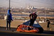 (Rick Egan | The Salt Lake Tribune) Homeless people drag their belongings across Victory Road as authorities clear an encampment in the area on Thursday, December 14, 2023. Utah's first ever homeless mortality report found unsheltered people are dying at 10 times the rate of housed people.
