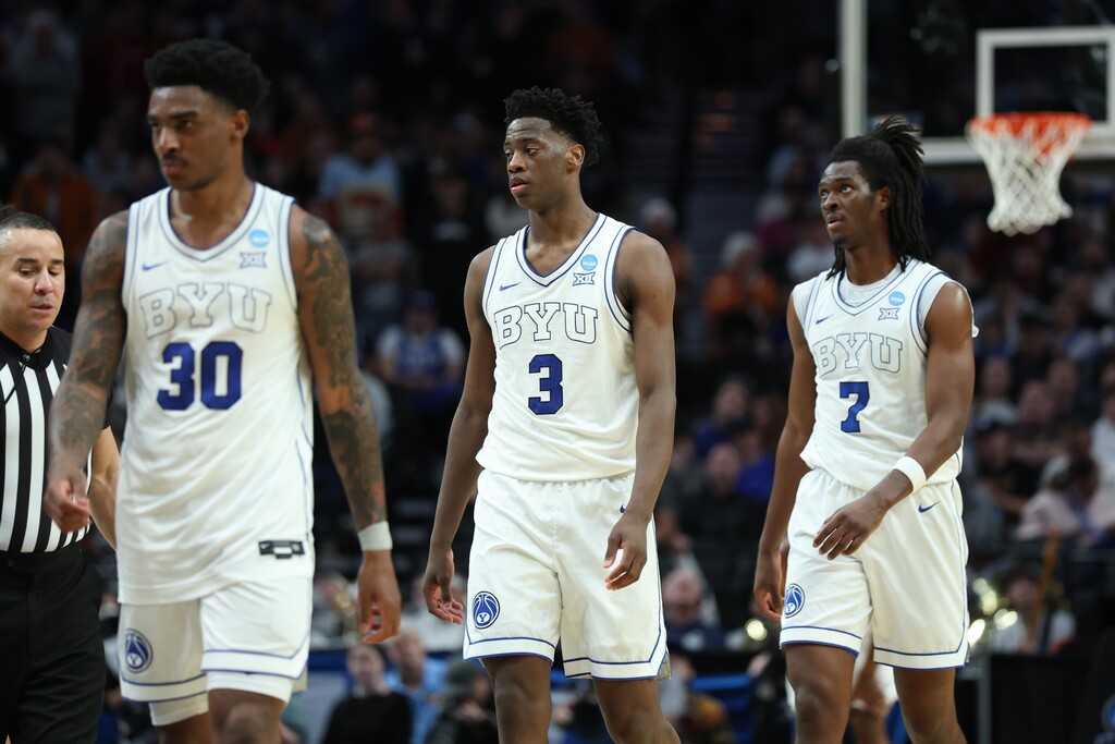 (Craig Mitchelldyer | AP) BYU guard Kennard Davis Jr. (30), forward AJ Dybantsa (3) and forward Khadim Mboup (7) react after losing in the first round of the NCAA college basketball tournament against Texas, Thursday, March 19, 2026, in Portland, Ore.