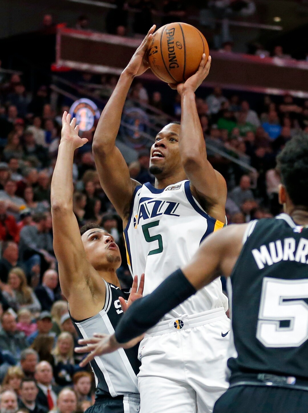 San Antonio Spurs guard Bryn Forbes, left, defends Utah Jazz guard Rodney Hood (5) during the first half of an NBA basketball game Thursday, Dec. 21, 2017, in Salt Lake City. (AP Photo/Rick Bowmer)