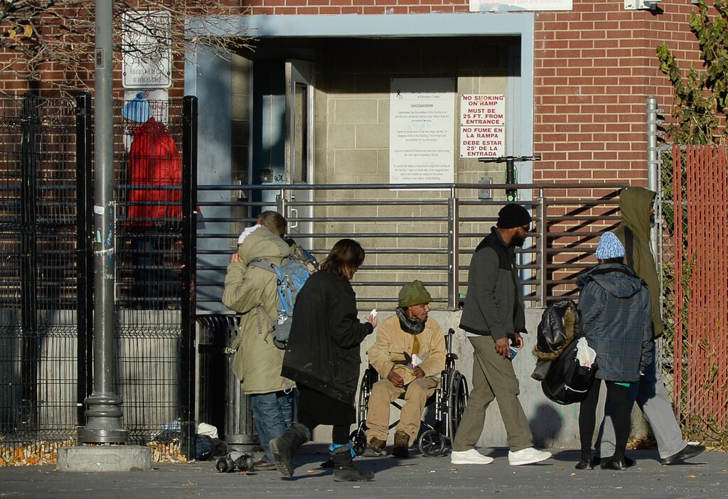 (Francisco Kjolseth  |  The Salt Lake Tribune)  People gather outside the men's side entrance to the Road Home in Salt Lake City at the end of the day on Wed. Oct. 30, 2019.