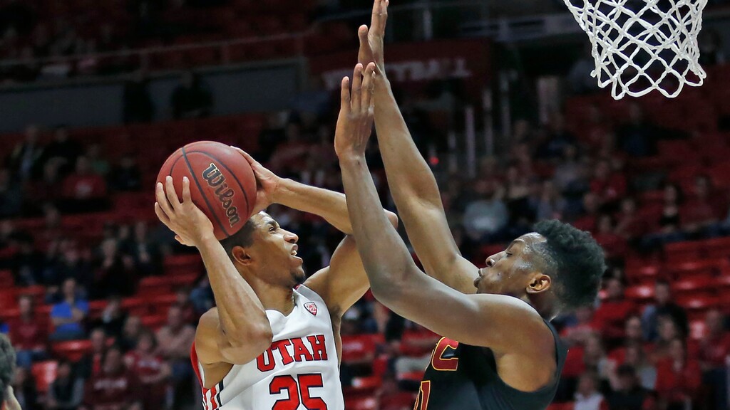 Utah guard Alfonso Plummer (25) goes to the basket as Southern California forward Onyeka Okongwu (21) defends in the second half during an NCAA college basketball game Sunday, Feb. 23, 2020, in Salt Lake City. (AP Photo/Rick Bowmer)