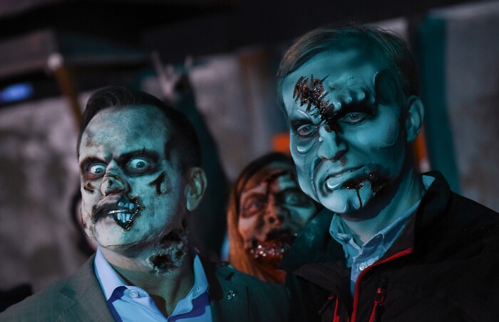 (Francisco Kjolseth  |  The Salt Lake Tribune)  Utah House Speaker Greg Hughes and Salt Lake County Mayor Ben McAdams are joined by Salt Lake County Councilmember Jenny Wilson, center, as local politicians fall prey to the zombie apocalypse at the Fear Factory on Thursday, Oct. 12, 2017, for a special event to raise awareness of the Utah Food Bank and kick start donations. 