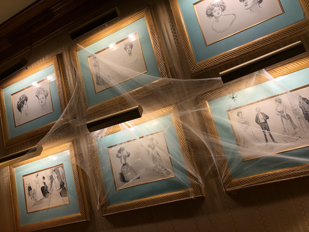 (Kolbie Peterson | The Salt Lake Tribune) "Gibson girl" portraits are bedecked with cobwebs at The Ghost of Gibson lounge in The Grand America Hotel on Thursday, Oct. 3, 2024.
