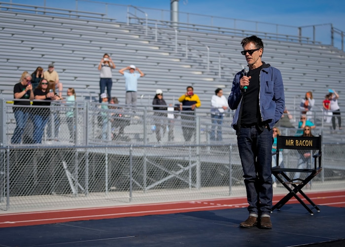 (Bethany Baker | The Salt Lake Tribune) Kevin Bacon speaks at a charity event to commemorate the 40th anniversary of the movie "Footloose" on the football field of Payson High School in Payson on Saturday, April 20, 2024.