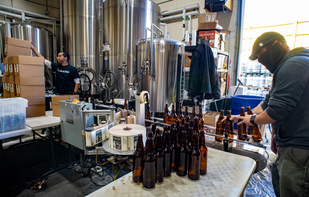 (Rick Egan  |  The Salt Lake Tribune)    Jordan Vigil and Aaron Buckner bottle beer at Epic Brewing Co. in Salt Lake City, Thursday, Oct. 29, 2020.