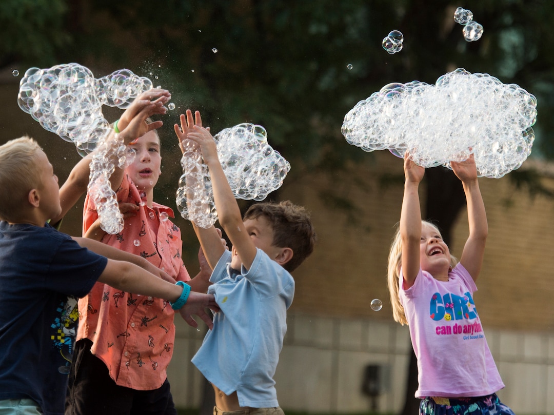 (Rick Egan  |  The Salt Lake Tribune)      Kids chase bubbles as they fall from the bubble tower at the Utah State Fair, Thursday, Sept. 6, 2018.