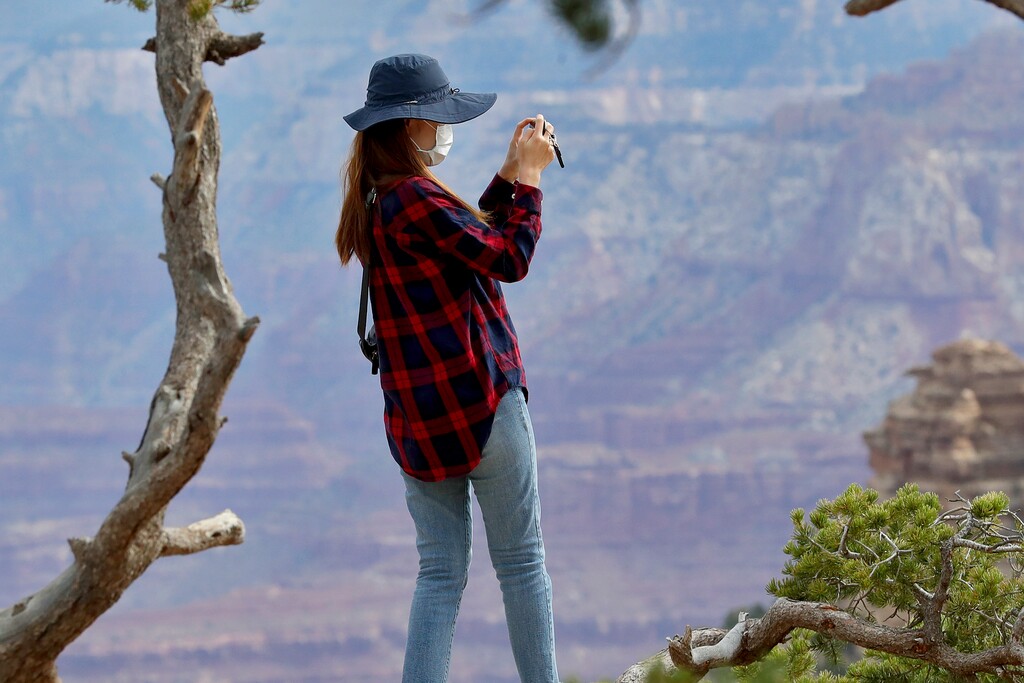 (Matt York | AP file photo) A visitor takes a photo at the Grand Canyon Friday, May 15, 2020, in Grand Canyon, Ariz. President-elect Joe Biden may be ready to shut down an attempt to open the door to mining near the Grand Canyon.
