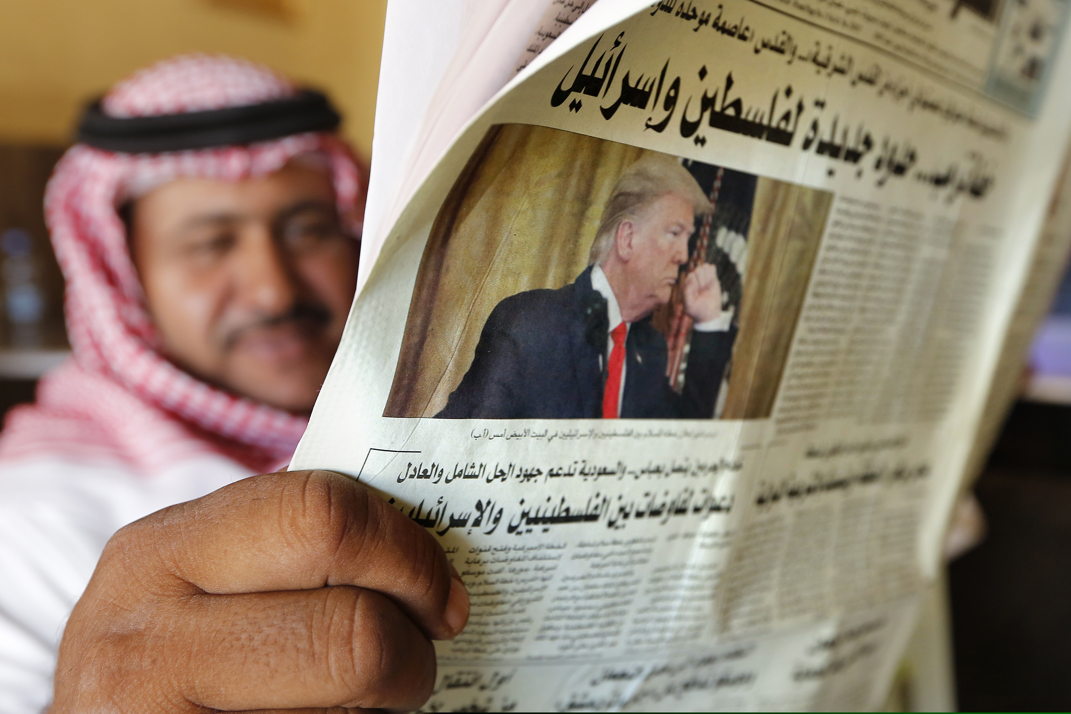 (Amr Nabil | AP) A man holds the daily Asharq Al-Awsat newspaper fronted by a picture of President Donald Trump, at a coffee shop in Jiddah, Saudi Arabia, Wednesday, Jan. 29, 2020.